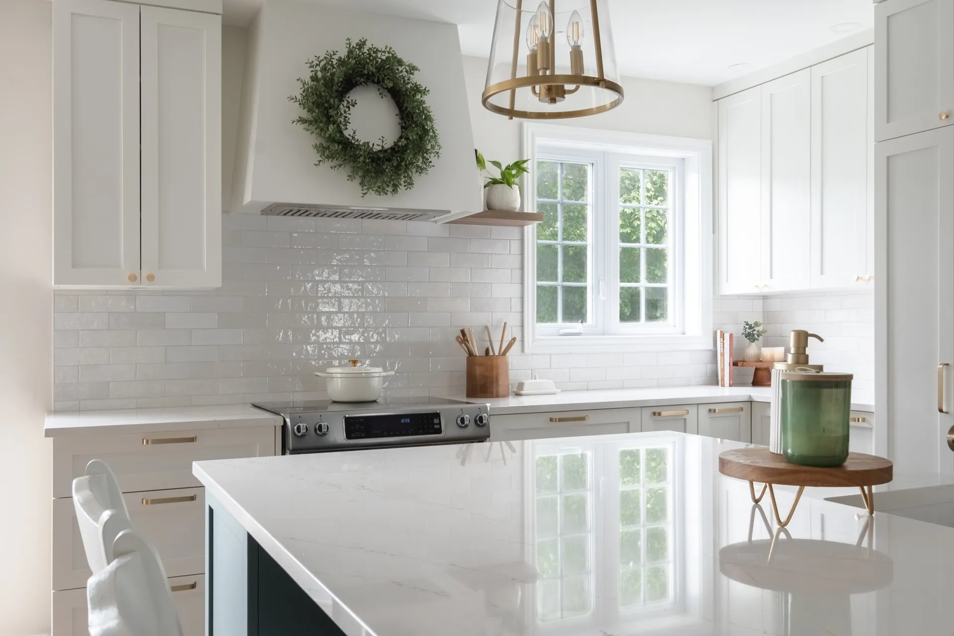 Modern off-white kitchen with island, marble countertop, white subway backsplash, custom Menuitech cabinets