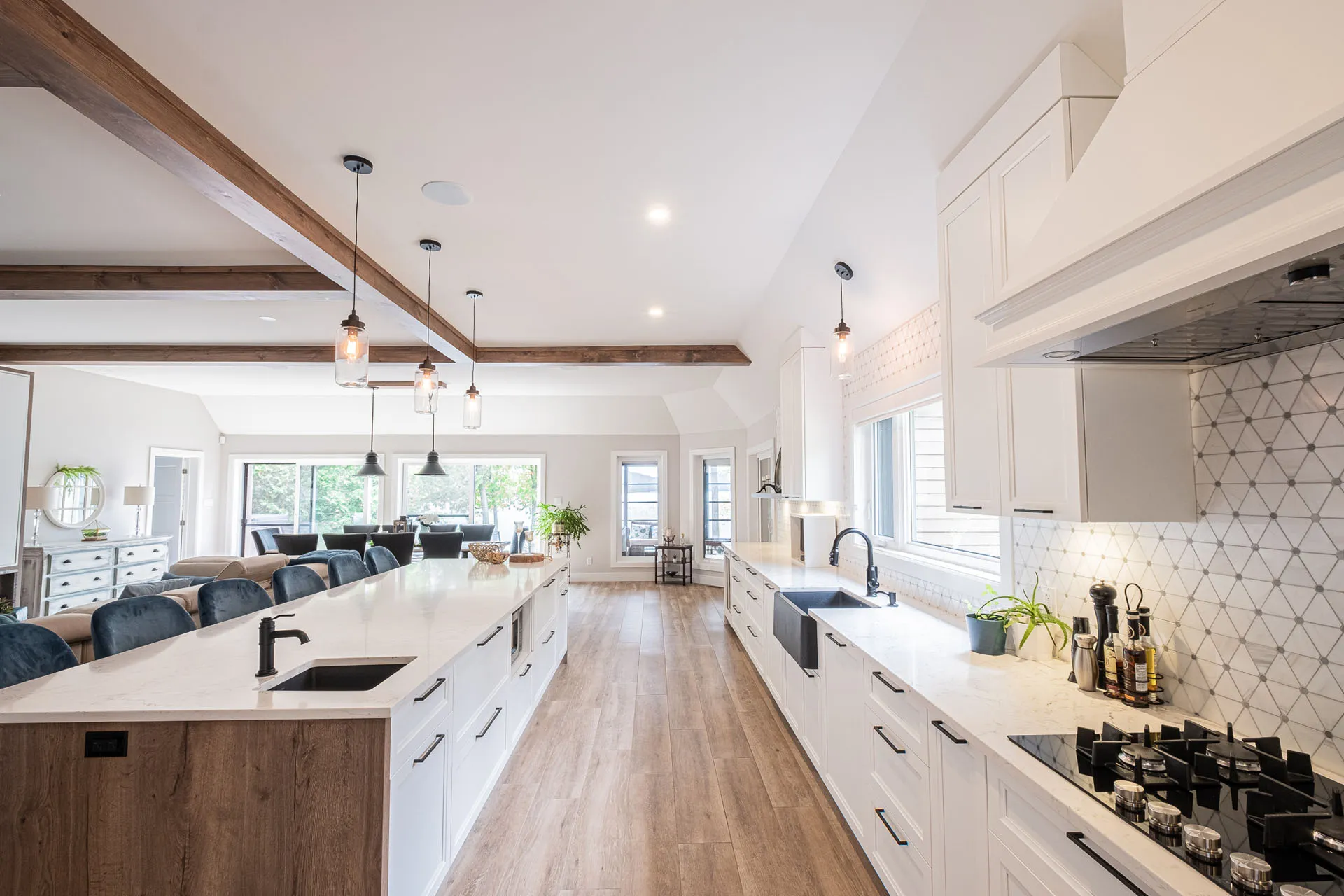 Modern Menuitech kitchen white and wood: island with quartz countertop, white cabinetry, geometric backsplash, pendant lighting