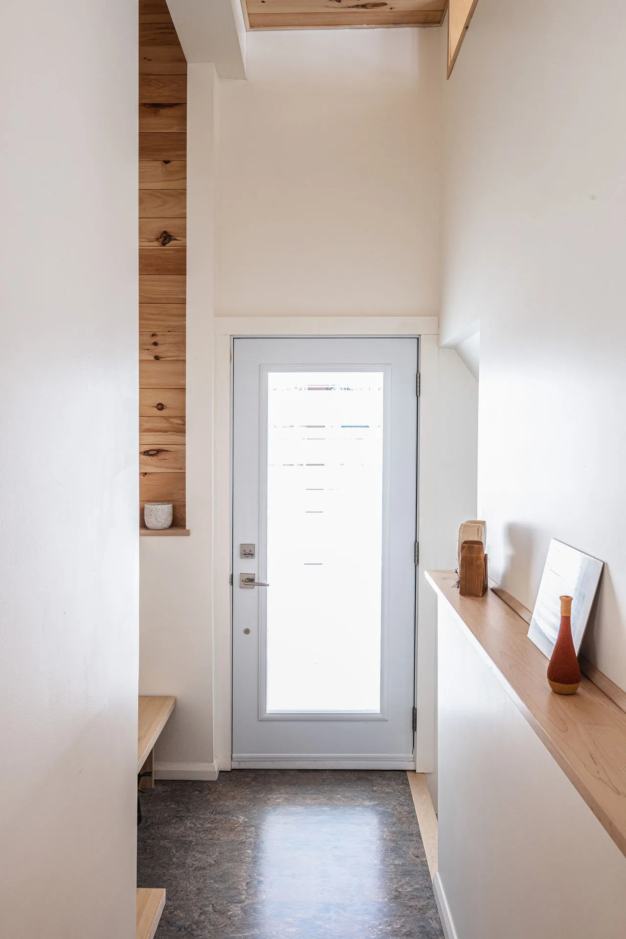 Narrow hallway with glass door, light wood countertops, white walls, natural lighting, Valière Menuitech project