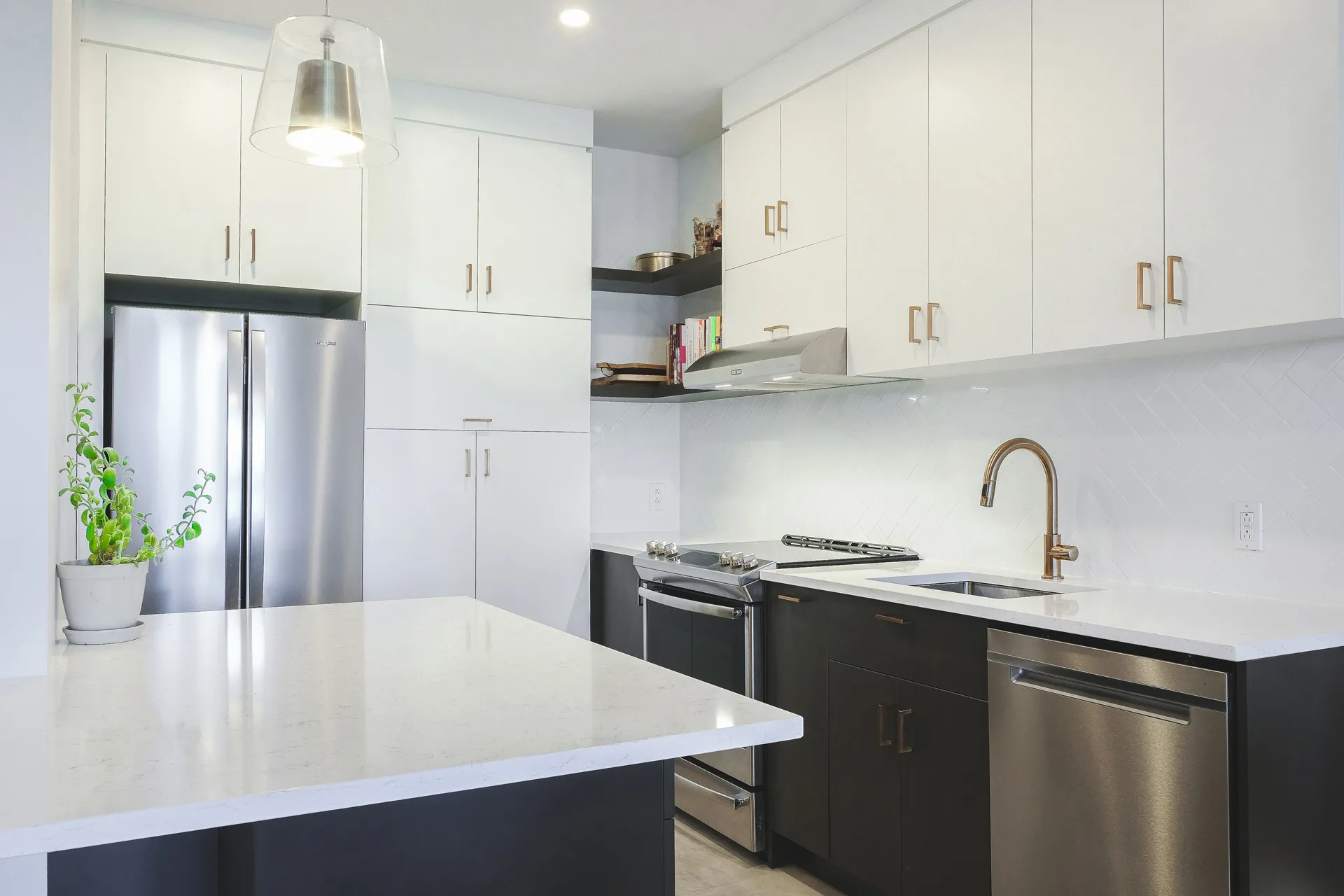 Modern Cavanagh kitchen: white and black cabinets, white quartz countertop, island, glossy backsplash, stainless steel appliances