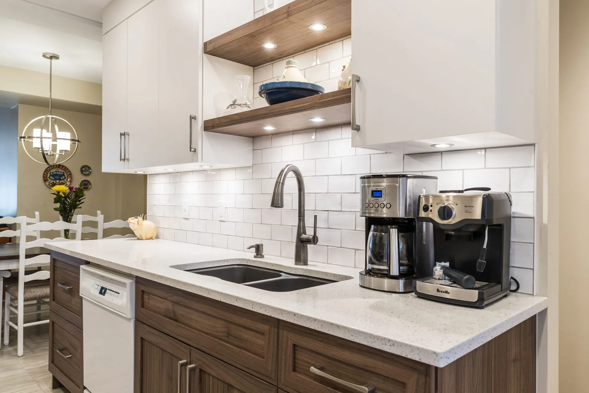 Modern Mathieu kitchen Montreal: white and wood cabinets, grey countertop, island with double sink, white subway backsplash, wood shelves