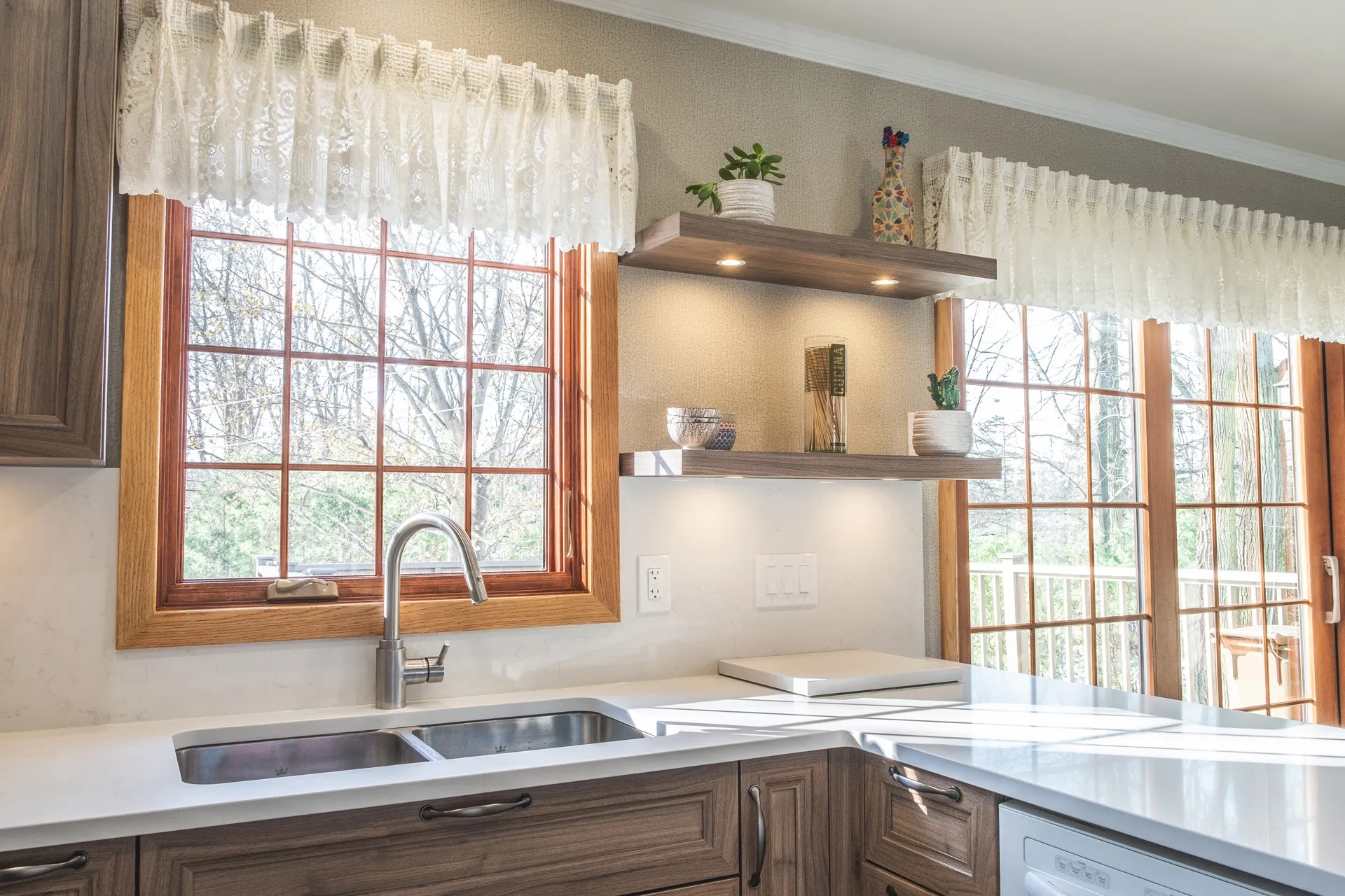 Nadon Kitchen Rosemère: walnut cabinetry, white countertops, island, wood windows, floating shelves, white backsplash