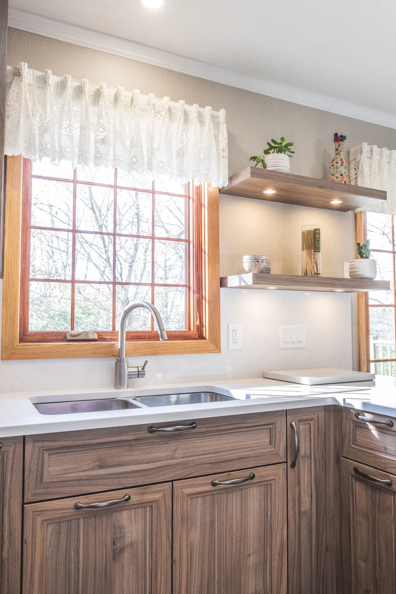 Nadon kitchen Rosemère: walnut cabinets, white countertop, wood window, floating shelves, integrated appliances