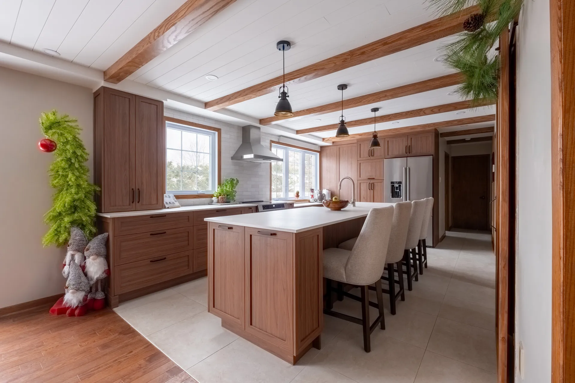 Lemay kitchen by Menuitech: walnut cabinets, white island countertop, tile backsplash, wood beams, black pendants
