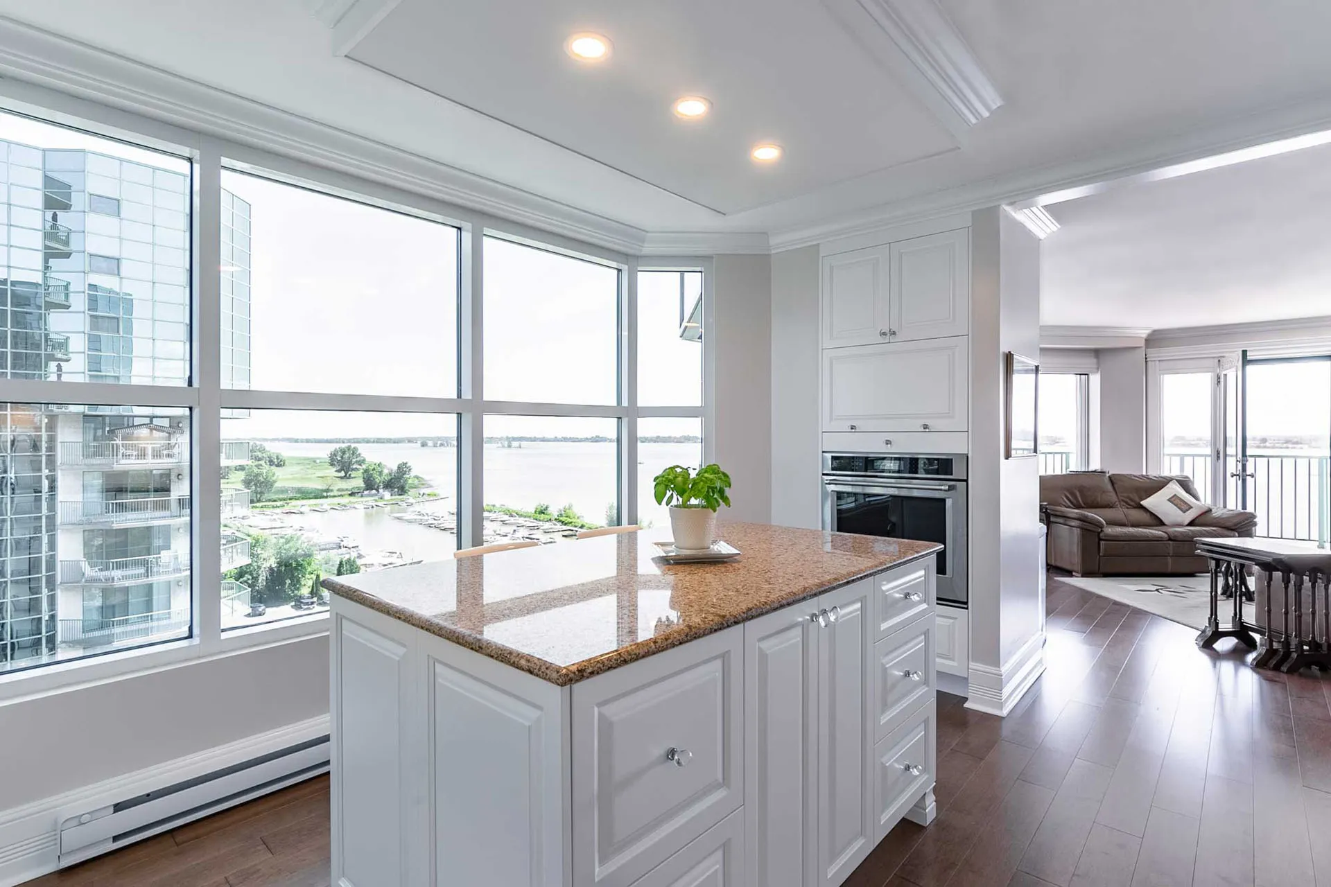 McDuff kitchen Repentigny: white cabinets, granite island, river view, recessed lighting