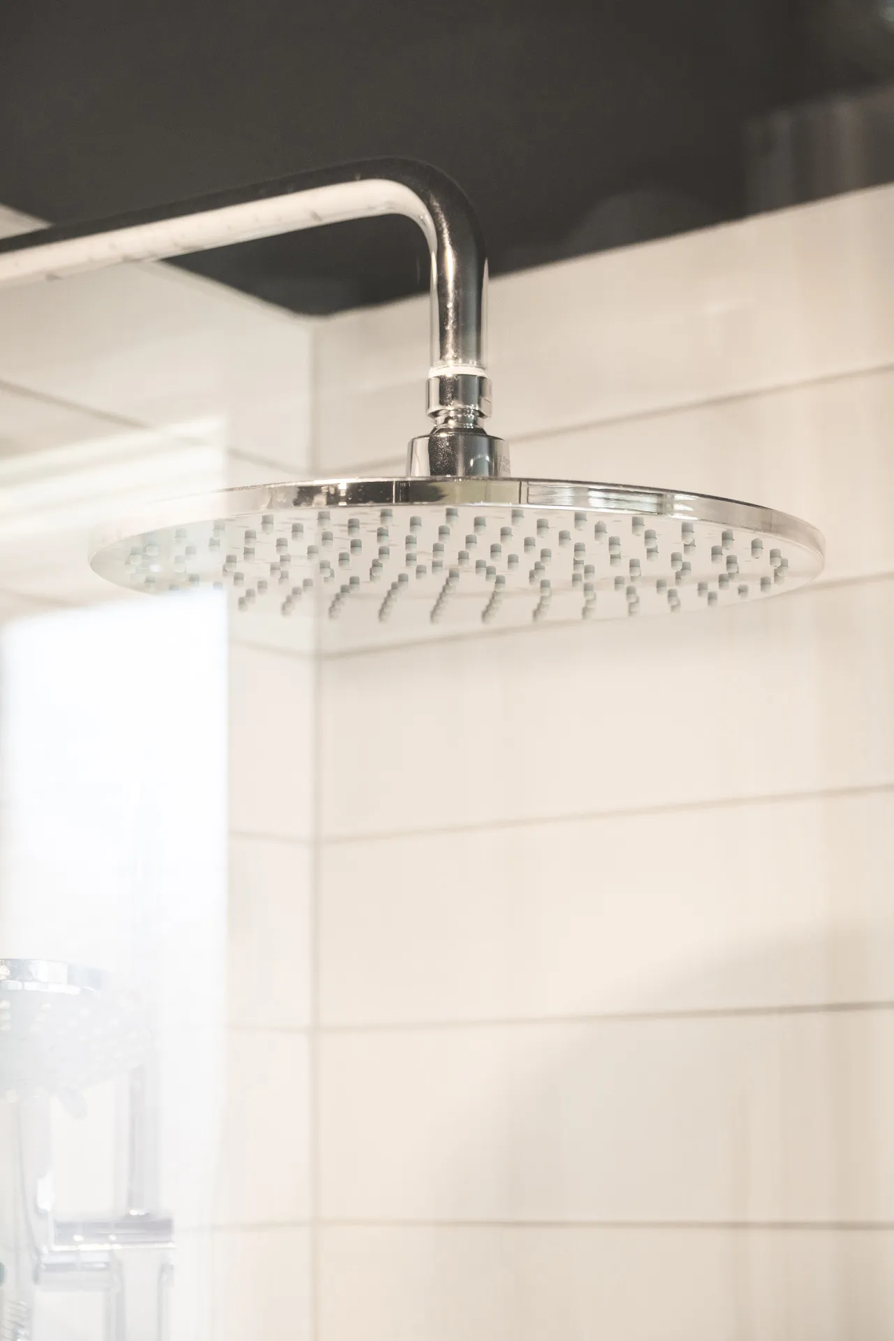 Modern bathroom with white subway tile backsplash and chrome rainfall showerhead