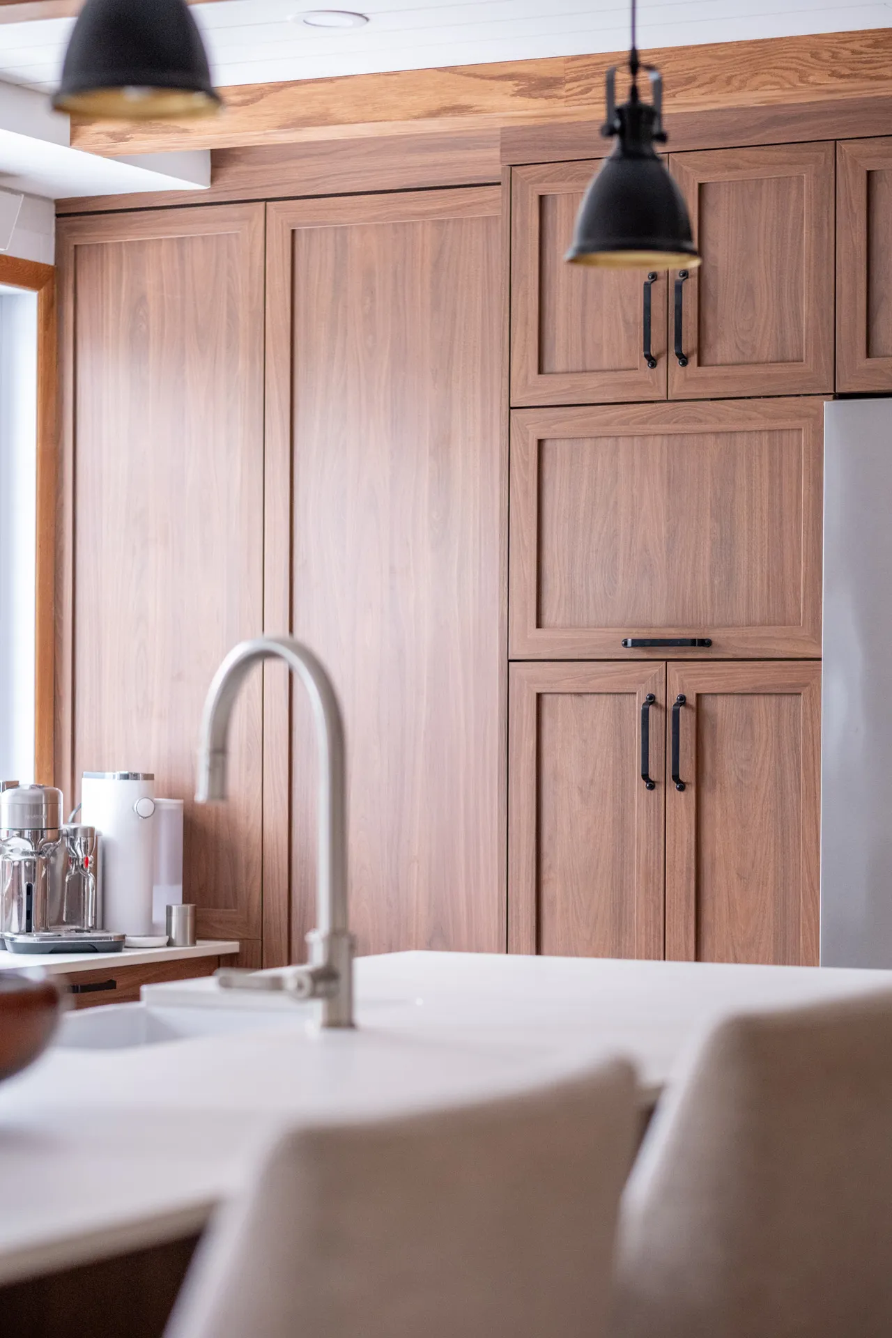 Lemay Kitchen Laval: natural wood cabinets, white countertop, arch faucet sink, black pendant lights