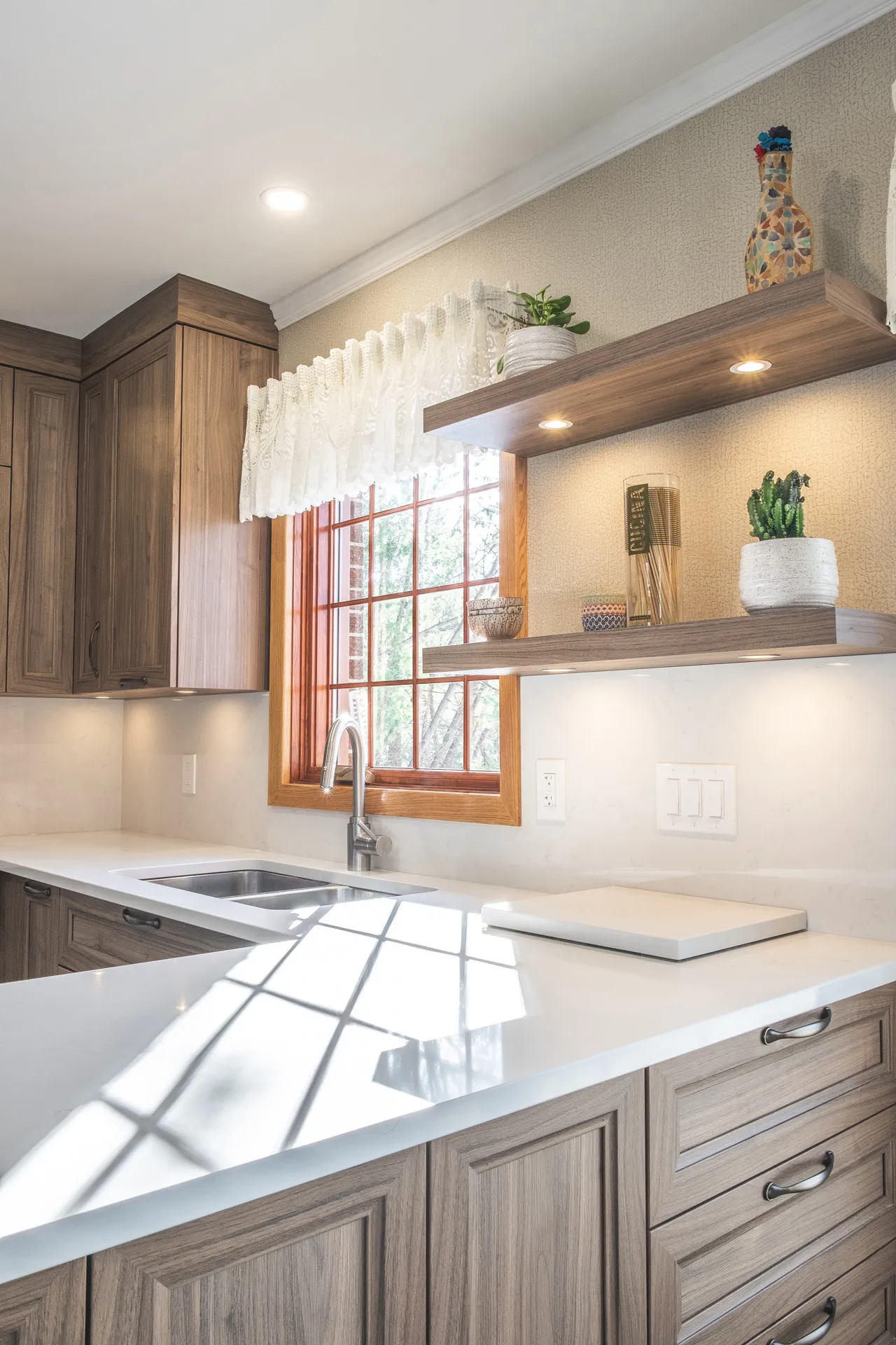 Nadon Kitchen Rosemère: grey cabinets, white countertop, island, wood window, floating shelves, beige backsplash