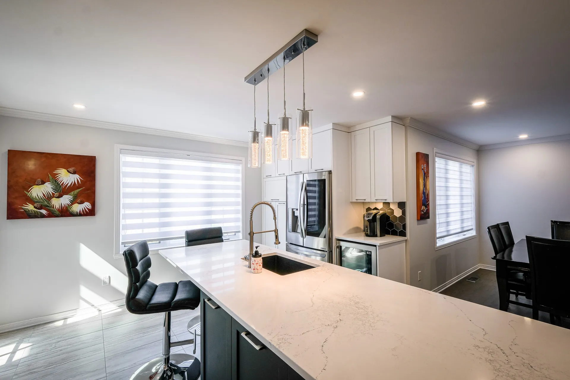 Landry kitchen Boisbriand: cream cabinets, marble countertop, black island, hexagonal backsplash, pendant lights